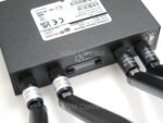 Image of the rear panel of the R2010 router showing antennas and SIM card holders slot with secure cover